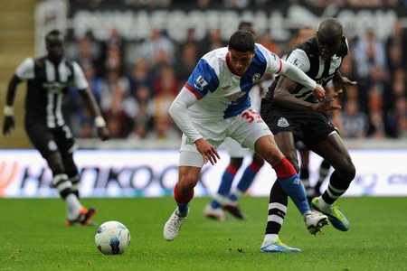 NEWCASTLE UPON TYNE, ENGLAND - SEPTEMBER 24:  Jason Lowe of Blackburn is tackled by Demba Ba of Newcastle during the Barclays Premier League match between Newcastle United and Blackburn Rovers at St James' Park on September 24, 2011 in Newcastle upon Tyne, England.  (Photo by Gareth Copley/Getty Images)