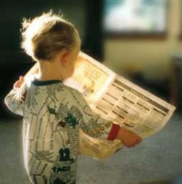 Child_reading_newspaper_medium